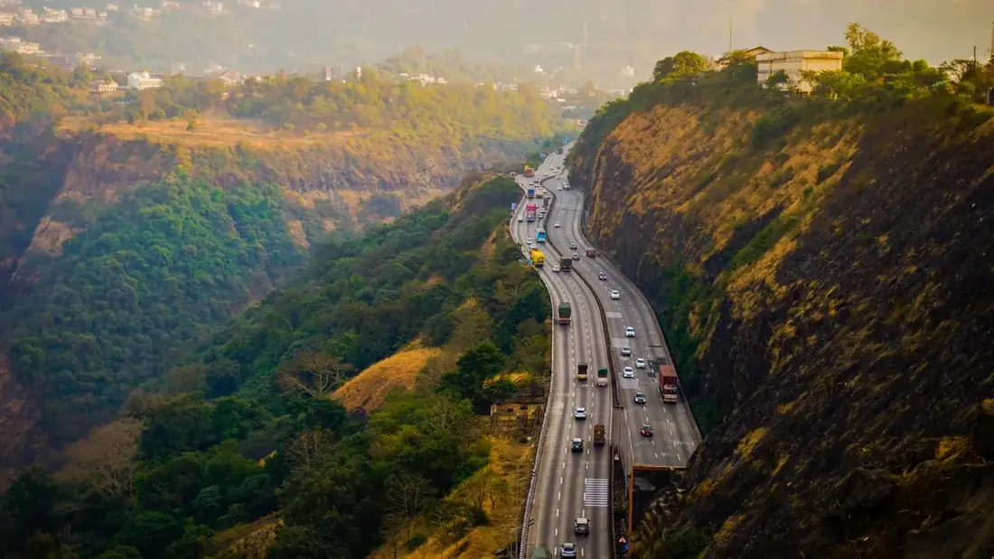 A highway curving through the forested hills of the Western Ghats